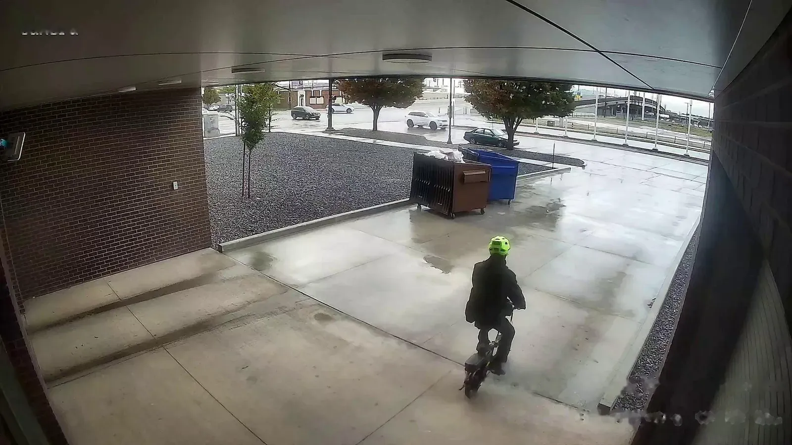 Person and vehicles at a garage entrance